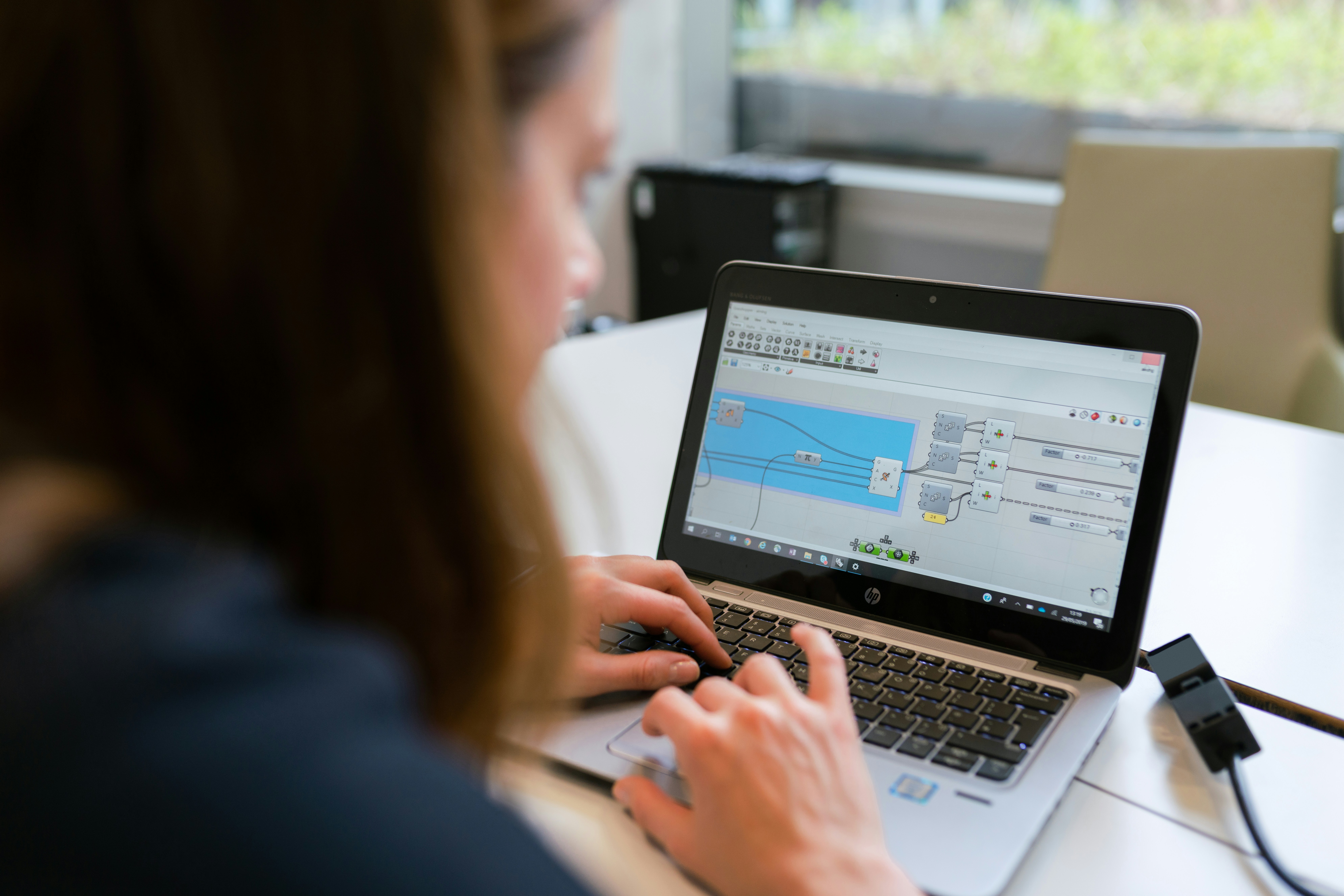 Female electrical engineer designs lighting on laptop