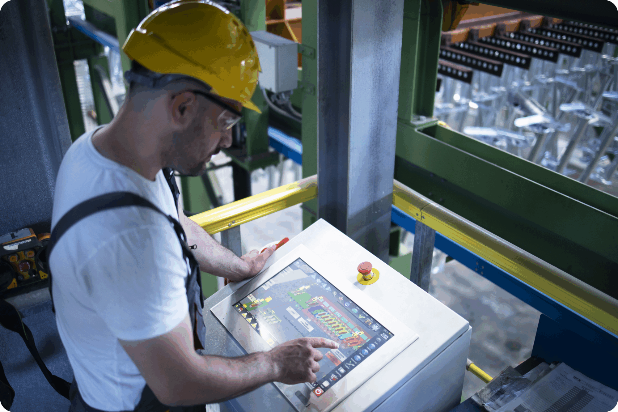 Factory worker monitoring industrial machines and production remotely in control room