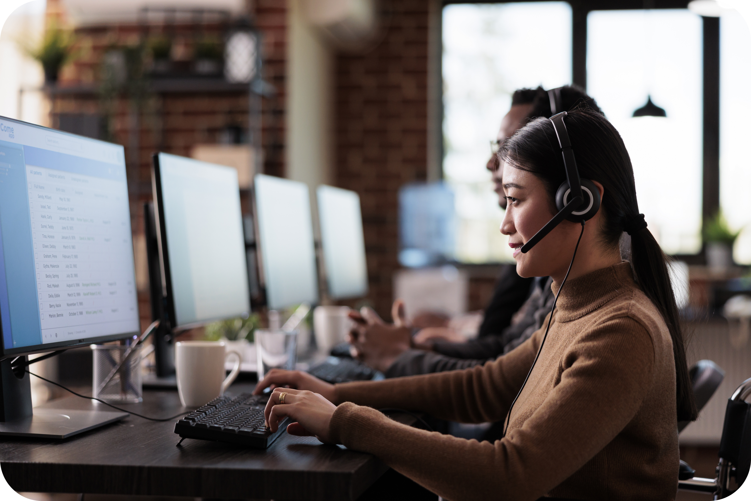 IT support specialist wearing a headset and working at a computer in a managed services operations center, providing remote technical assistance and monitoring systems.