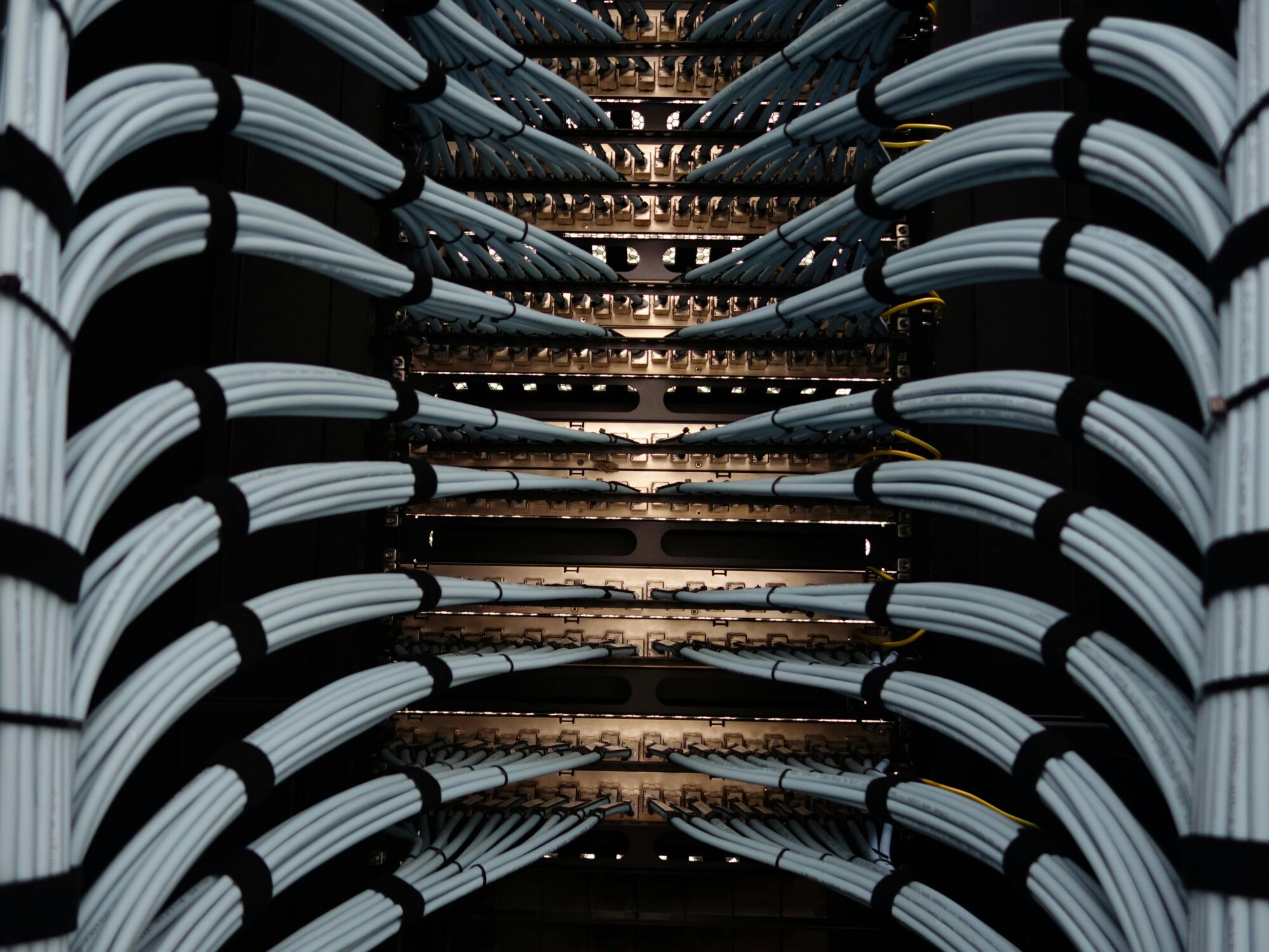 Neatly organized network cables connected to patch panels in a server rack