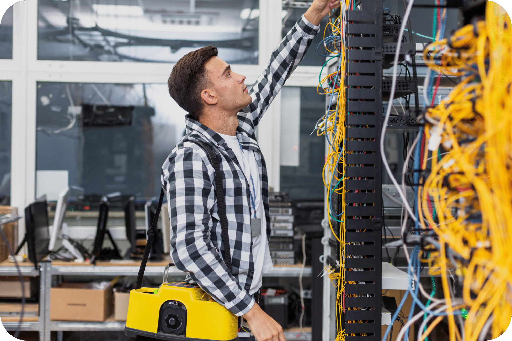 Technician organizing tangled network cables in server rack