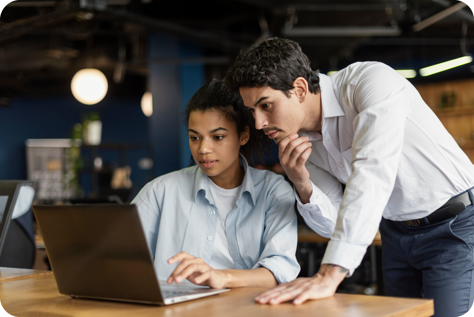 Two coworkers discussing information in laptop