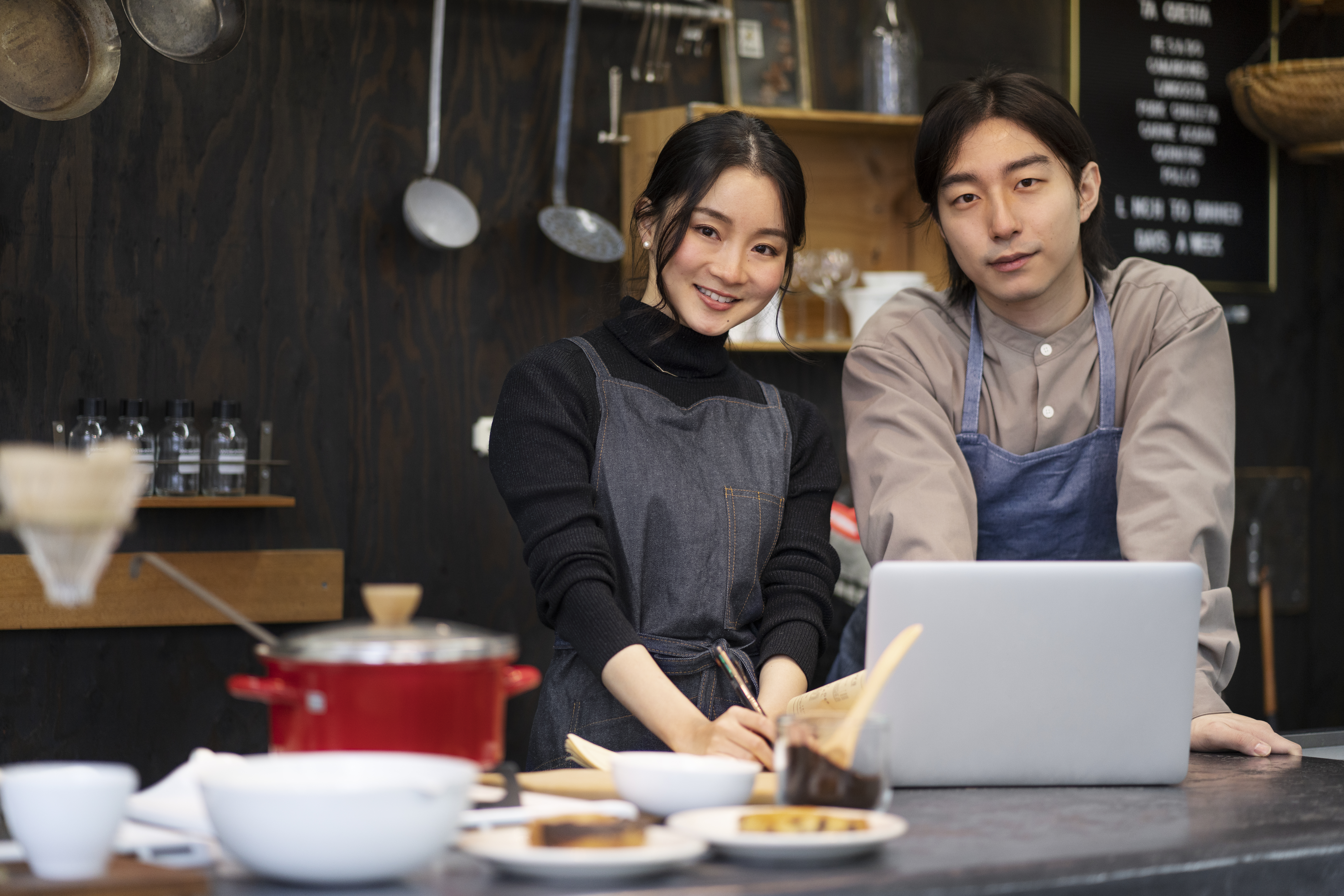 Small business owners using laptop at a restaurant counter