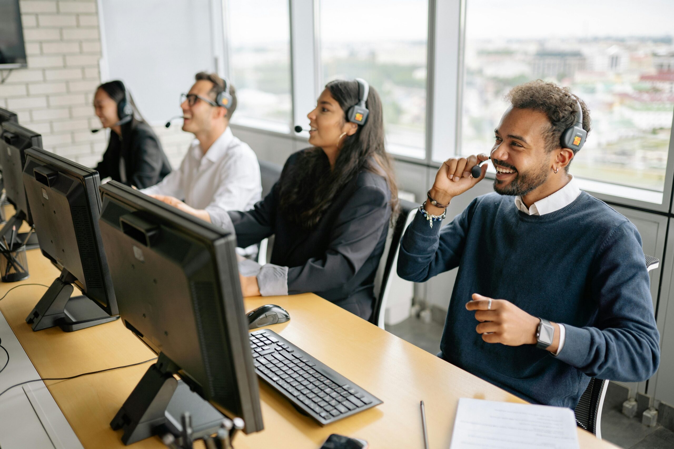 Smiling IT support specialists in bright office